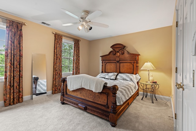 bedroom with light carpet, baseboards, and ceiling fan