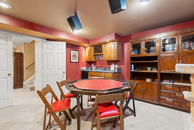 dining space featuring light colored carpet, wet bar, and stairway