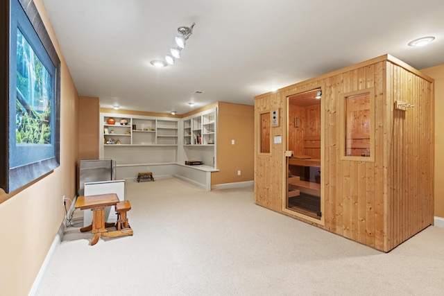 living area featuring carpet and baseboards