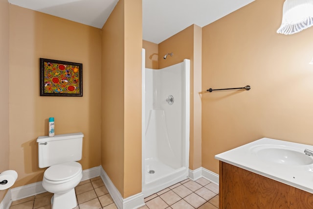 bathroom featuring a shower, toilet, tile patterned flooring, baseboards, and vanity