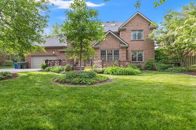 traditional-style home with brick siding, a front yard, and driveway
