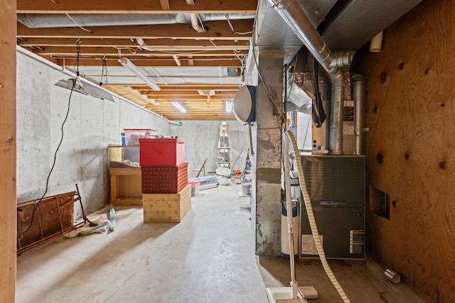 unfinished below grade area featuring heating unit