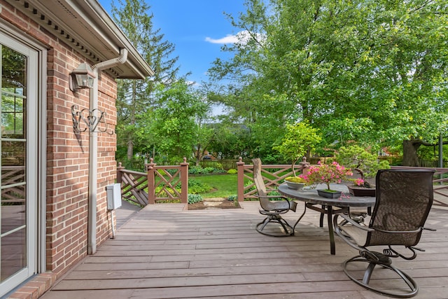 wooden deck featuring outdoor dining space and fence