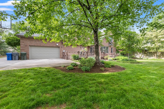view of property hidden behind natural elements featuring driveway, brick siding, and an attached garage