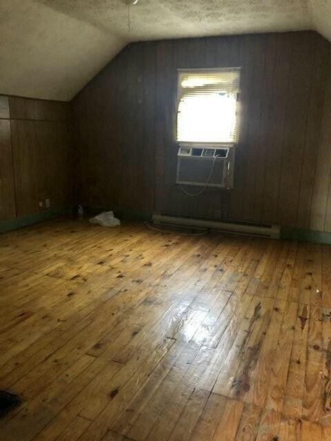 34 Owens Rd S, Clearfield, KY 40313 - bonus room with vaulted ceiling, cooling unit, a textured ceiling, baseboard heating, and hardwood / wood-style floors