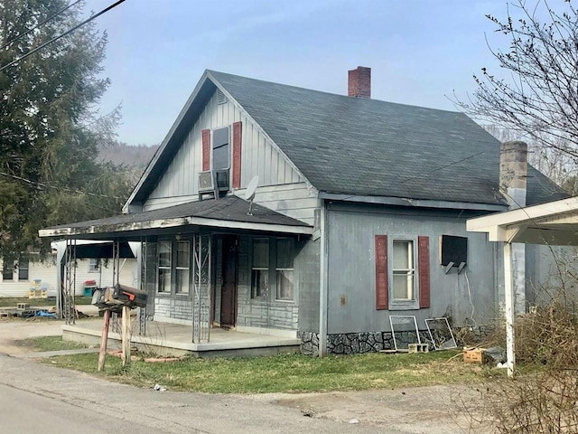 34 Owens Rd S, Clearfield, KY 40313 - view of front facade featuring a chimney, a shingled roof, and a porch