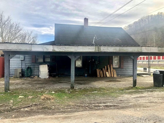 34 Owens Rd S, Clearfield, KY 40313 - back of property featuring a chimney, a carport, and central AC
