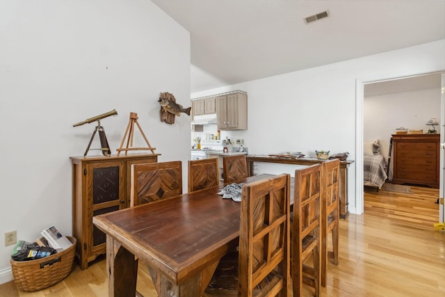 dining room featuring light wood-style flooring and visible vents
