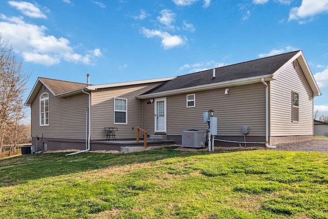 back of house featuring a lawn and cooling unit