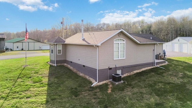 view of property exterior featuring crawl space, a garage, a yard, and central air condition unit