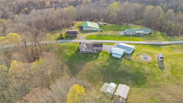 drone / aerial view featuring a forest view