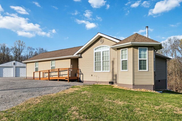 exterior space with an outdoor structure, crawl space, a deck, a front yard, and a garage