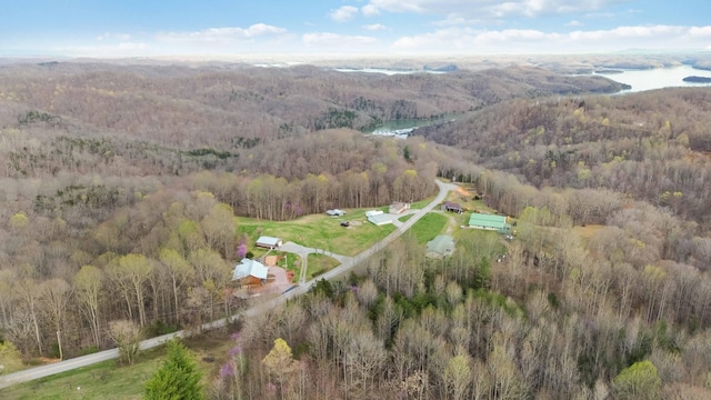 drone / aerial view featuring a water view and a forest view
