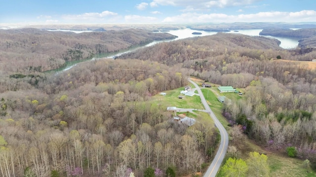 birds eye view of property featuring a water view and a forest view