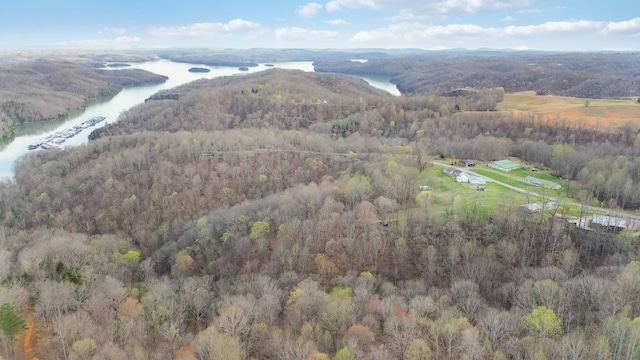 aerial view with a forest view and a water view