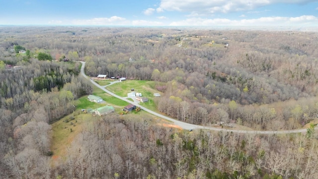 birds eye view of property featuring a wooded view