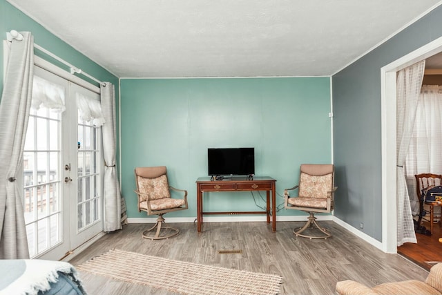 sitting room featuring baseboards and wood finished floors