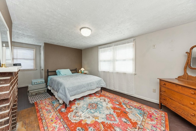 bedroom with a textured ceiling and baseboards