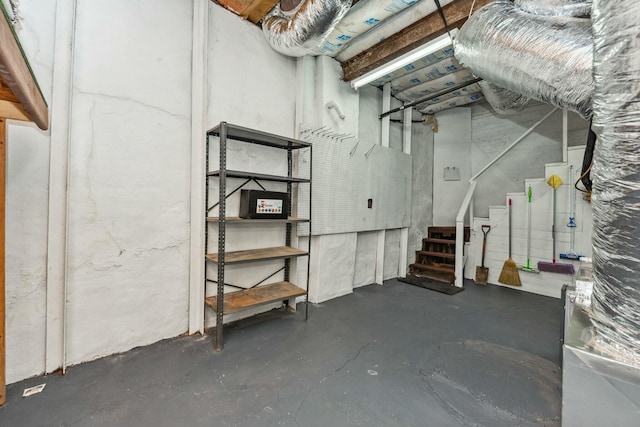 unfinished below grade area featuring stairway