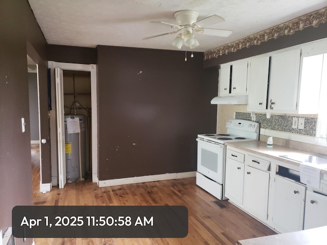 83 Riverside Loop, Lily, KY 40740 - kitchen with water heater, a ceiling fan, white cabinetry, white electric range, and under cabinet range hood