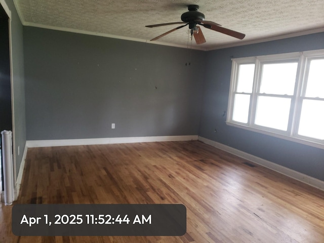 83 Riverside Loop, Lily, KY 40740 - spare room featuring a textured ceiling, wood finished floors, ornamental molding, and a ceiling fan