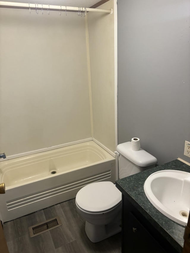 full bath with visible vents, wood finished floors, toilet, vanity, and  shower combination