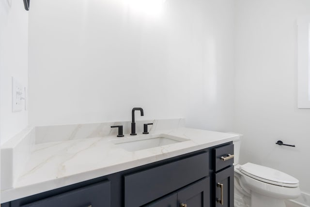 bathroom with toilet and vanity