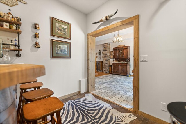 1295 Burger Knob Rd, Junction City, KY 40440 - interior space featuring a bar, baseboards, and a notable chandelier