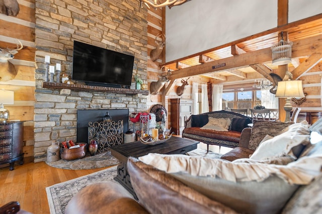 1295 Burger Knob Rd, Junction City, KY 40440 - living room featuring a high ceiling, a stone fireplace, beam ceiling, and wood finished floors