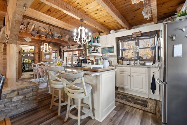 1295 Burger Knob Rd, Junction City, KY 40440 - kitchen with dark wood-style floors, a notable chandelier, white cabinetry, and freestanding refrigerator