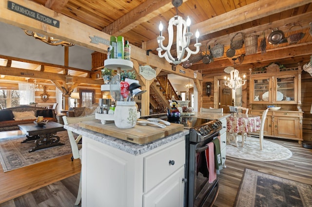 1295 Burger Knob Rd, Junction City, KY 40440 - kitchen with wood walls, an inviting chandelier, dark wood-style flooring, electric range, and beam ceiling