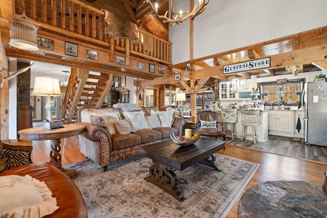 1295 Burger Knob Rd, Junction City, KY 40440 - living area featuring dark wood-style floors, a chandelier, stairway, and a towering ceiling
