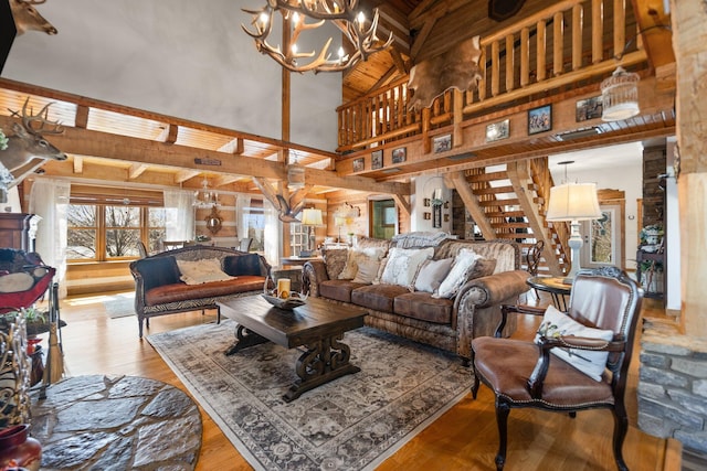 1295 Burger Knob Rd, Junction City, KY 40440 - living area with stairway, a chandelier, wood ceiling, beam ceiling, and wood finished floors