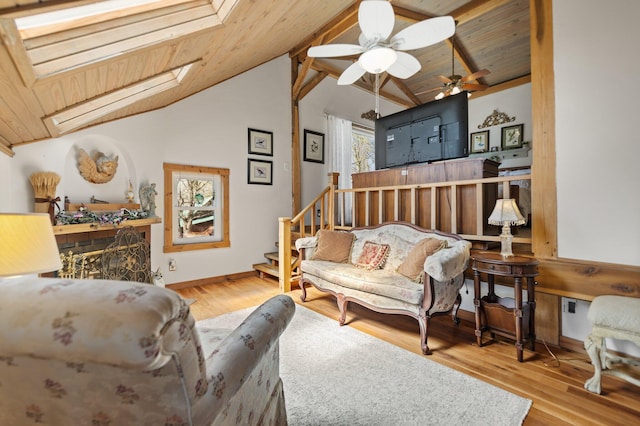 1295 Burger Knob Rd, Junction City, KY 40440 - living area featuring stairs, lofted ceiling with skylight, wood ceiling, ceiling fan, and wood finished floors