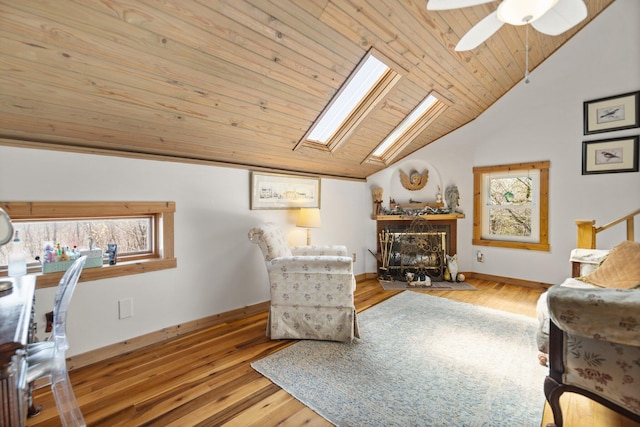 1295 Burger Knob Rd, Junction City, KY 40440 - living area with a fireplace, wood finished floors, a ceiling fan, lofted ceiling with skylight, and wooden ceiling