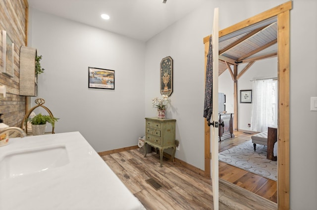 1295 Burger Knob Rd, Junction City, KY 40440 - bathroom featuring lofted ceiling with beams, visible vents, baseboards, wood finished floors, and a sink
