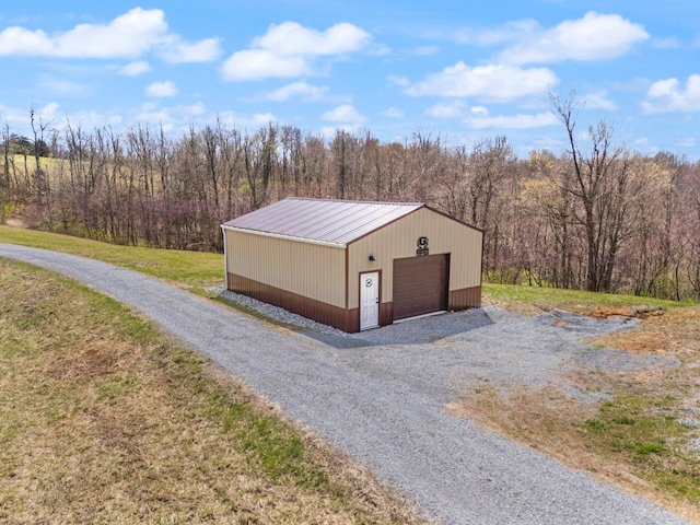 1295 Burger Knob Rd, Junction City, KY 40440 - view of property exterior featuring driveway, a view of trees, an outdoor structure, metal roof, and a garage