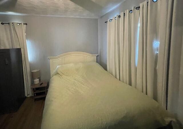 bedroom featuring dark wood-style flooring
