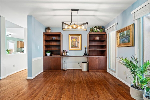 office space featuring baseboards and wood finished floors