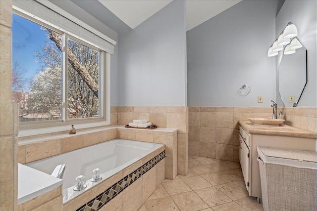 full bathroom with a wealth of natural light, tile patterned flooring, vanity, and a garden tub