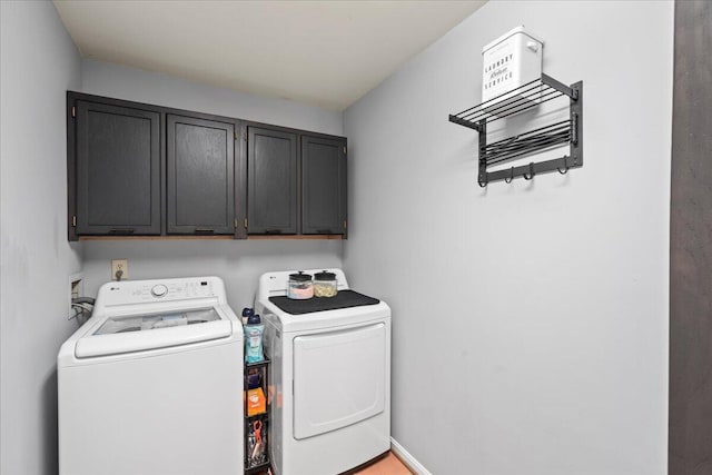 clothes washing area with independent washer and dryer and cabinet space