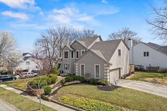 traditional-style home featuring a garage, a front yard, driveway, and a shingled roof