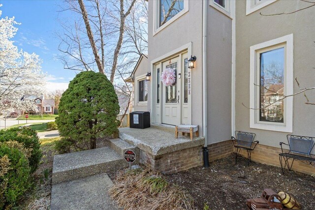 doorway to property with stucco siding