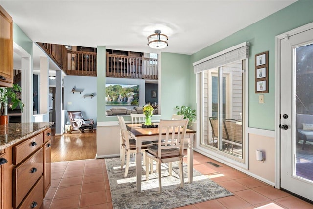 dining room with light tile patterned floors, plenty of natural light, and visible vents