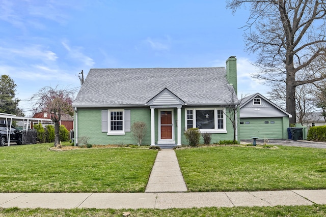 bungalow with driveway, a front yard, brick siding, a shingled roof, and a chimney