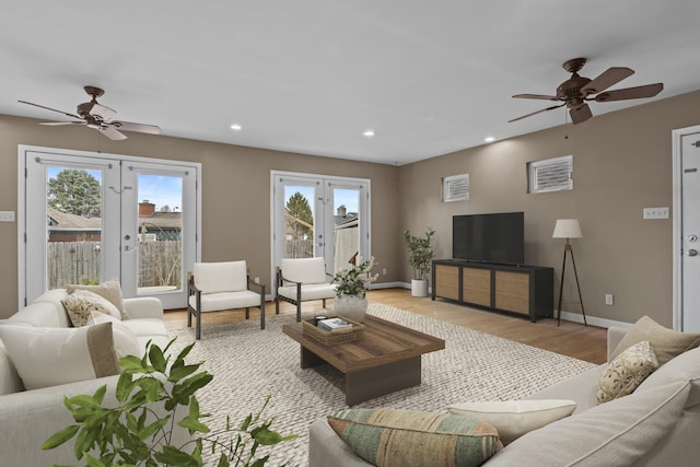 living area with a ceiling fan, recessed lighting, baseboards, and wood finished floors