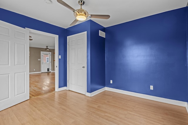 unfurnished bedroom with baseboards, visible vents, light wood-style floors, and a ceiling fan