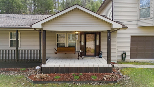 9485 US-60, Morehead, KY 40351 - view of exterior entry with covered porch, a garage, and a shingled roof