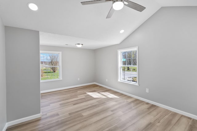 unfurnished room featuring baseboards, a ceiling fan, vaulted ceiling, and wood finished floors