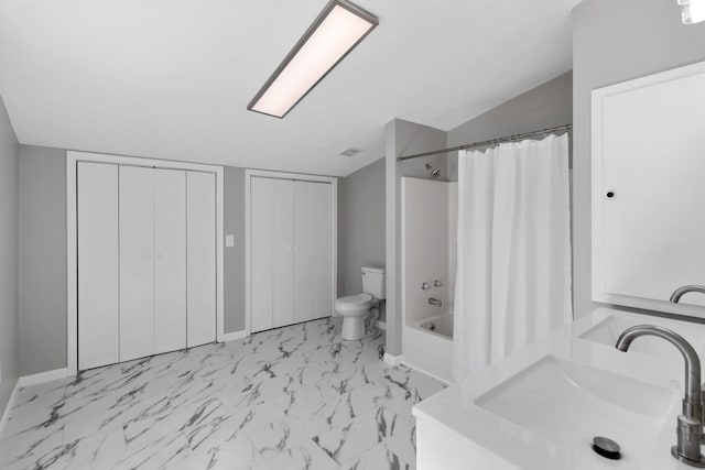 full bathroom featuring visible vents, toilet, marble finish floor, a sink, and shower / bath combo with shower curtain
